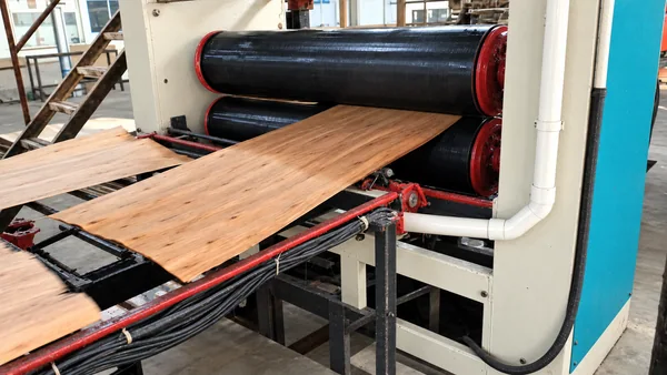 Veneer passing through our glue spreader